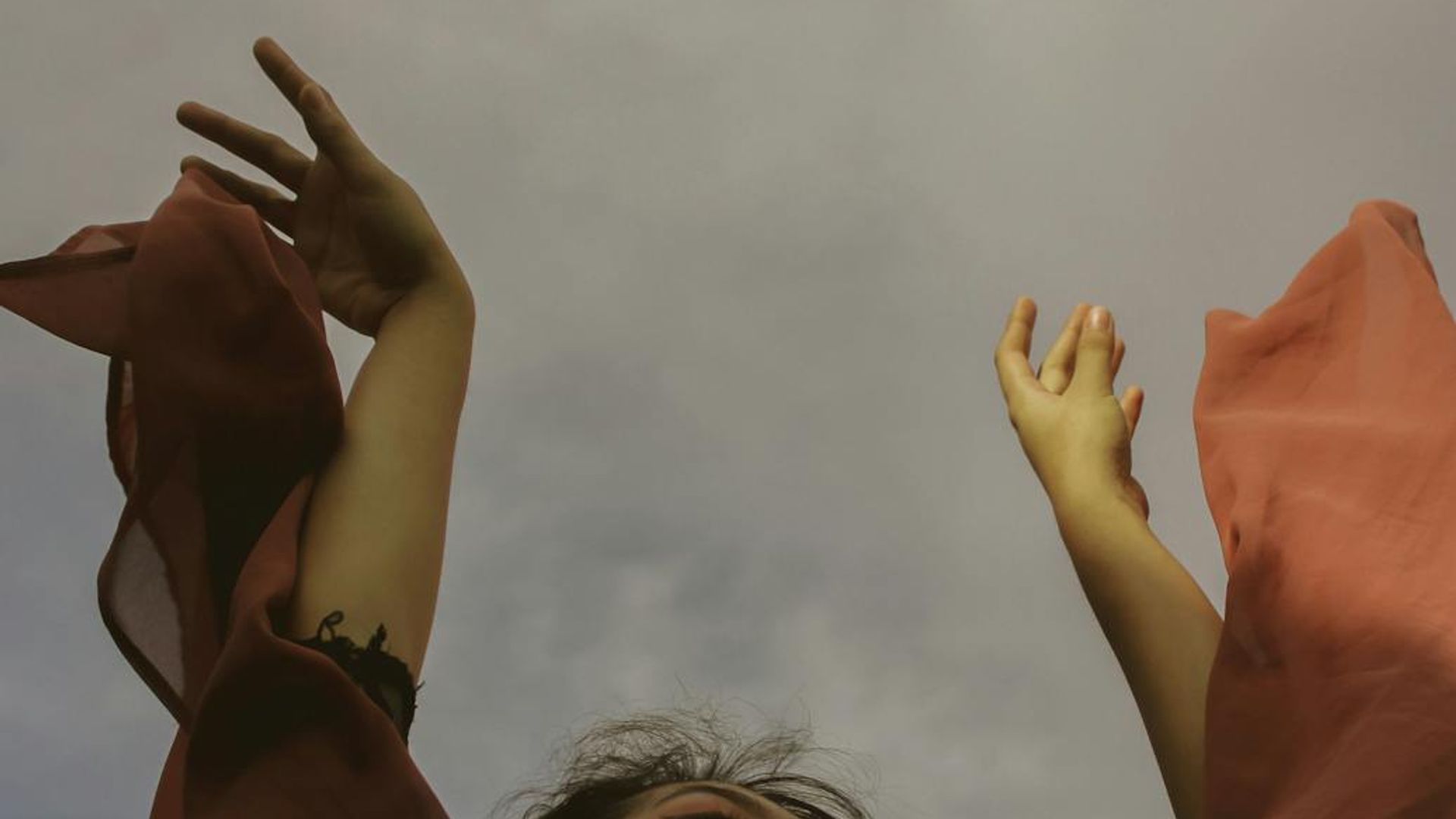 Silhouette of a person in a dynamic movement pose against a calm background.